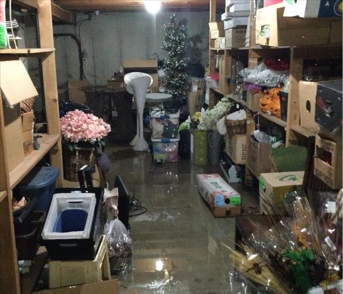 Flooded basement of flower shop with lots of products and seasonal items