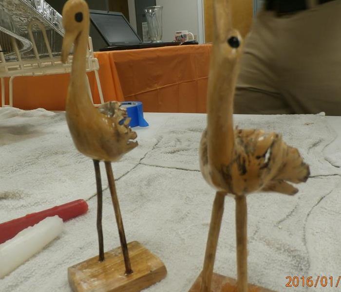 Wooden bird figurine after cleaning for water and mold damage