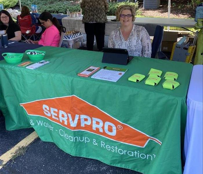 Photo of employee at job fair booth. 