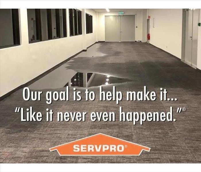 Image of a hallway with water in carpet and text our goal is to make it... "Like it never even happened" and SERVPRO logo