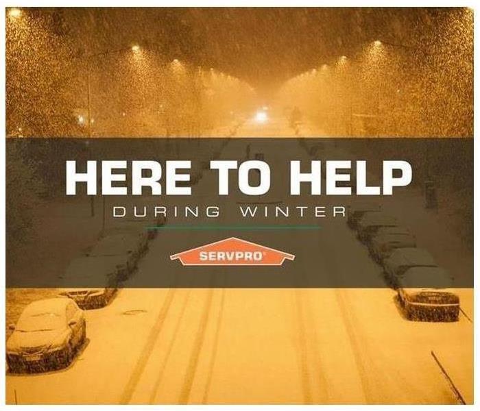 A night view of a snowed street with text Here to help during winter and SERVPRO logo
