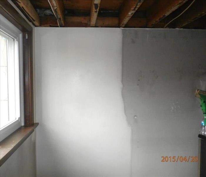 Image of a wall with right side having dark soot and left side cleaned